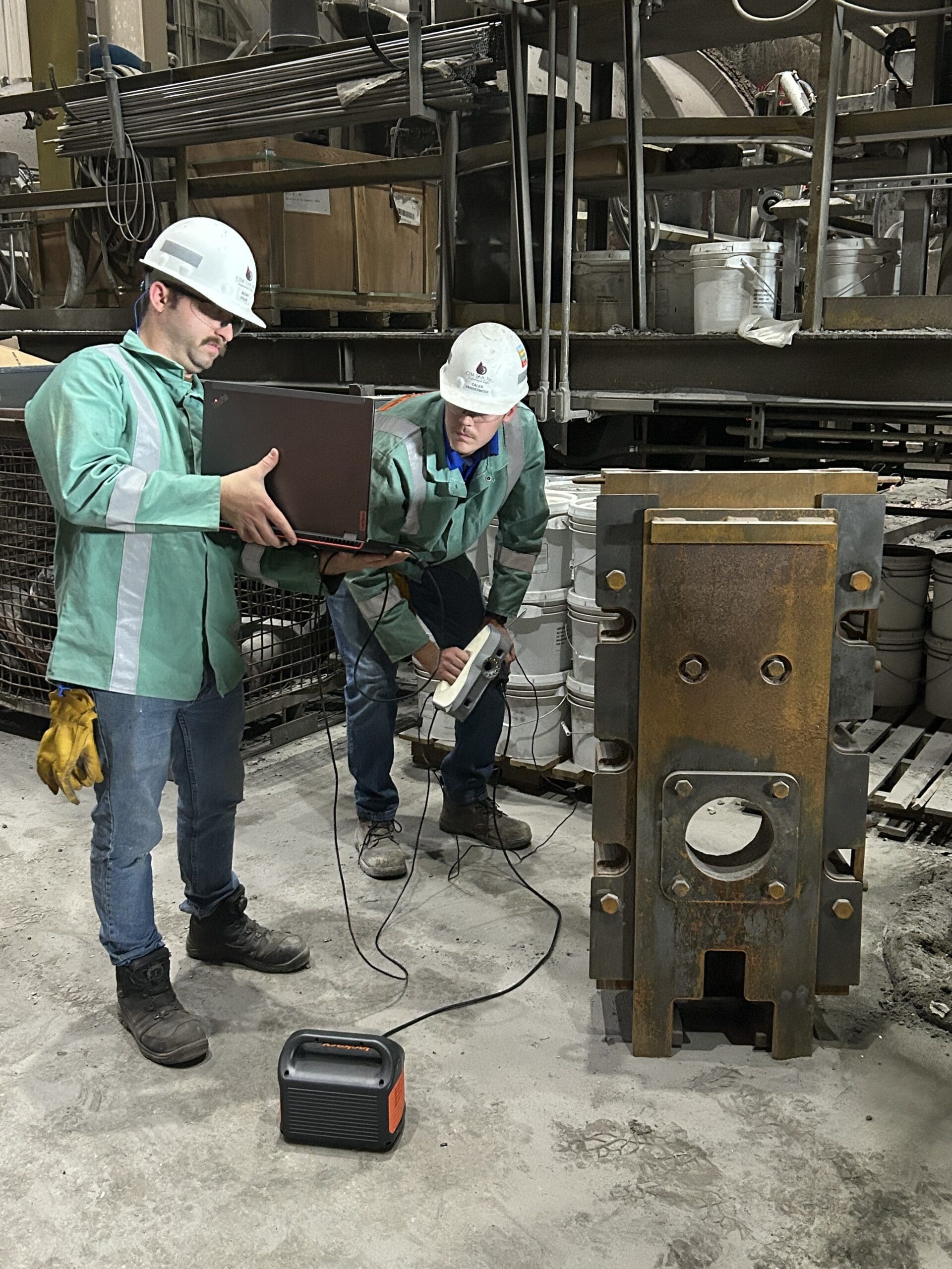 Engineers using a 3D scanner to inspect an industrial component