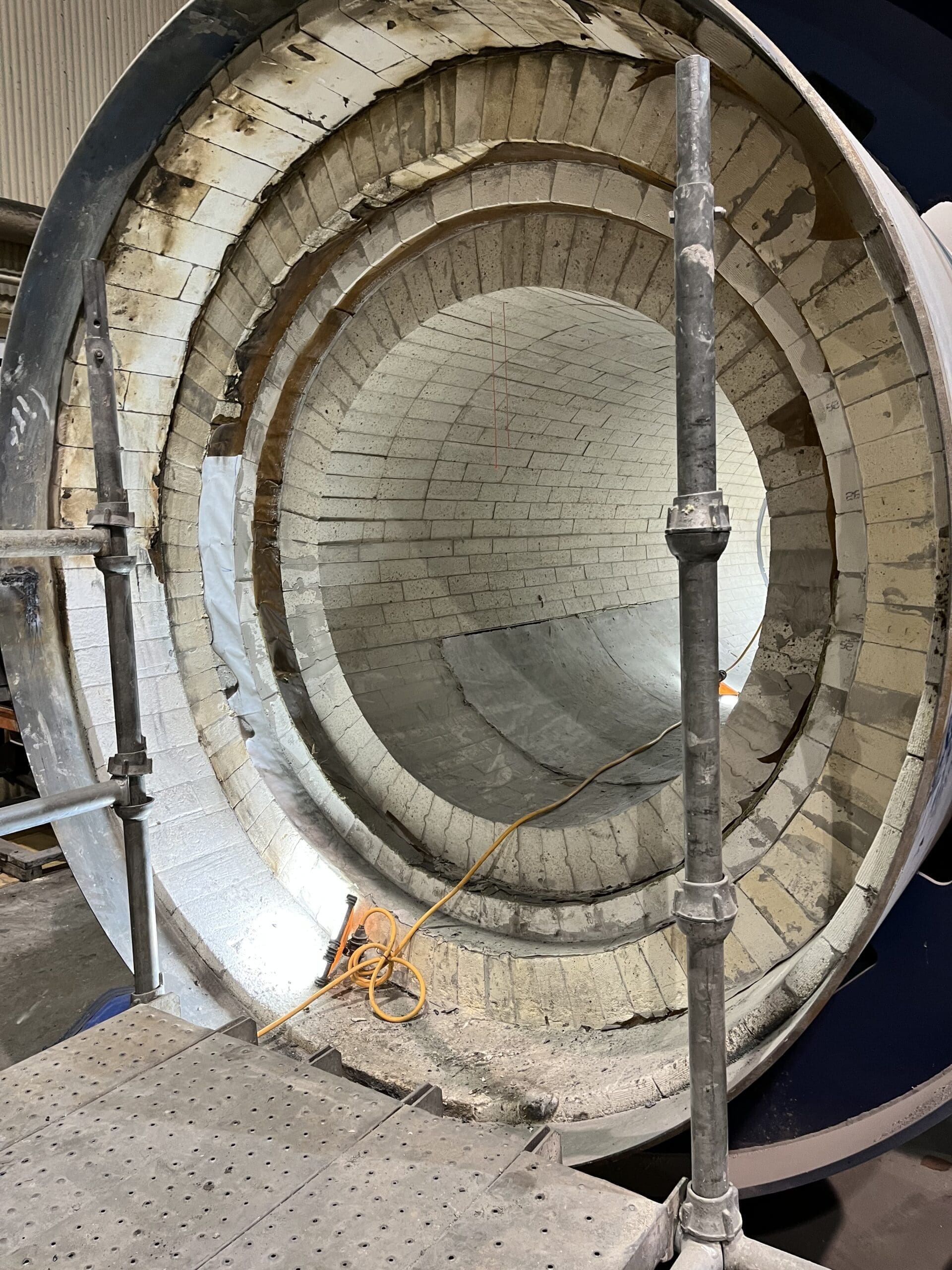 Interior of a brick-lined industrial kiln under construction